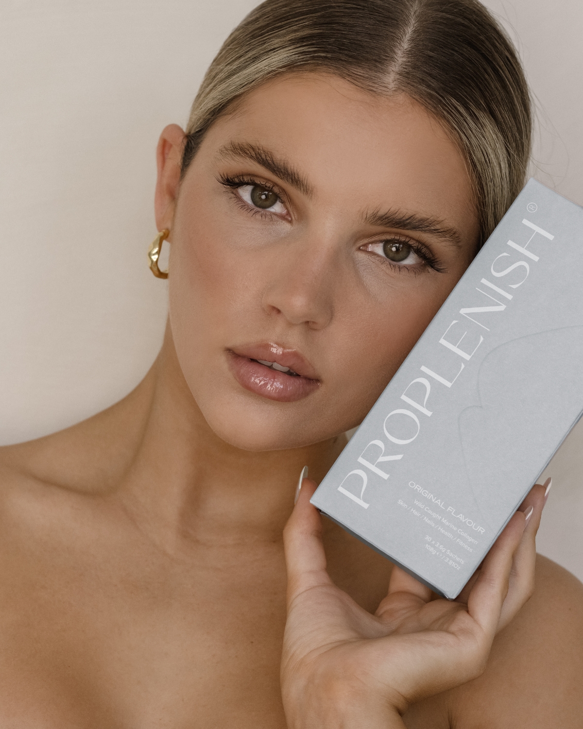 Woman holding ProPlenish Marine Collagen Original