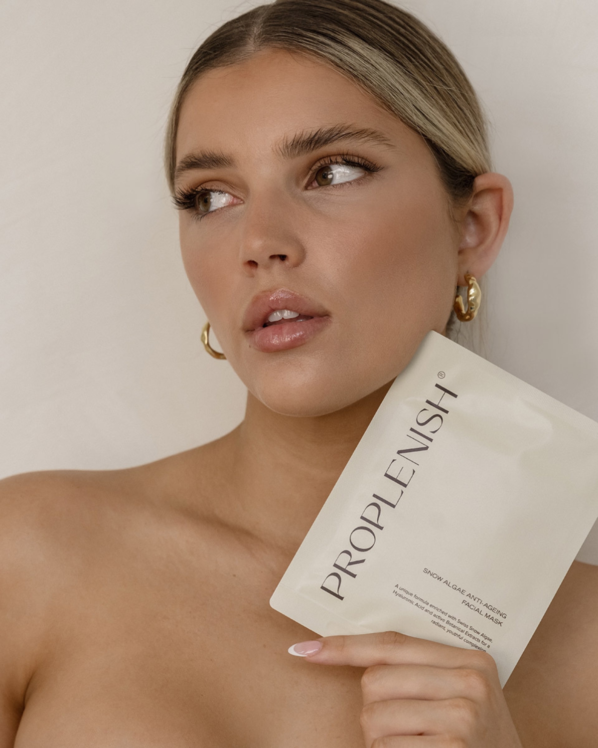 Woman holding ProPlenish Anti-ageing facial mask