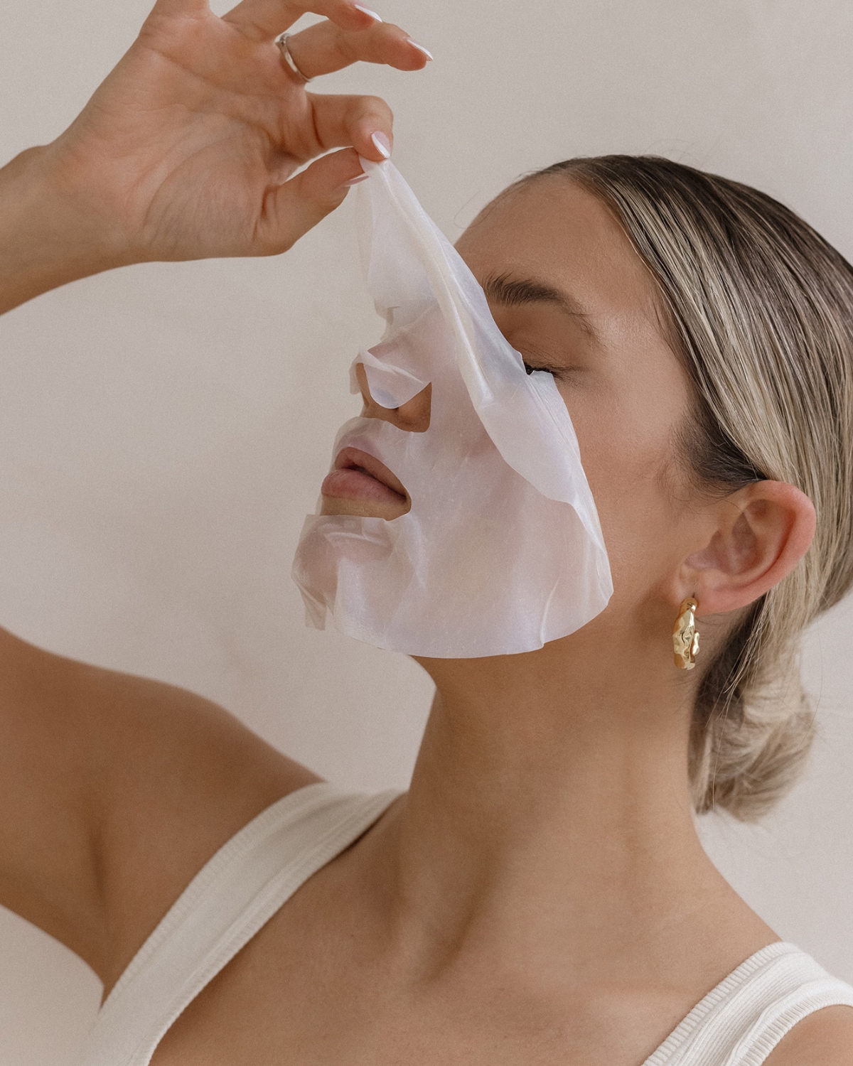 Woman removing ProPlenish Anti-ageing facial mask