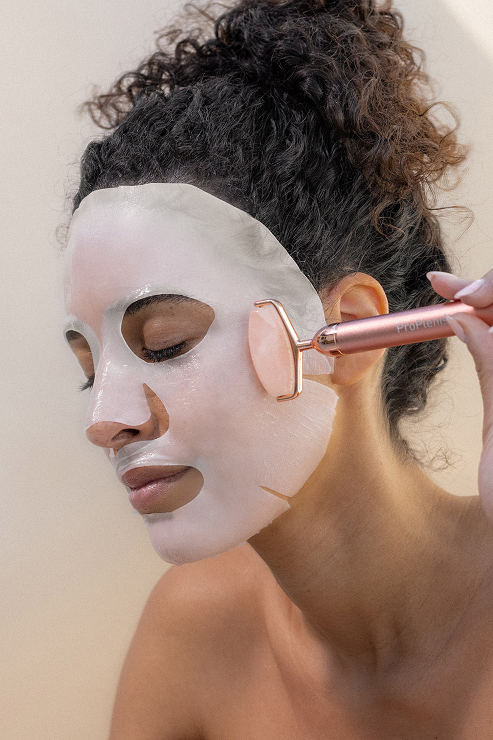 girl with rose quartz roller on face